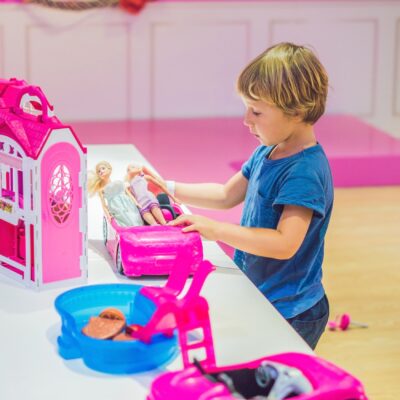 a young boy playing with dolls