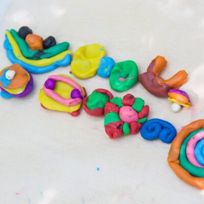 a line of small modeling clay creations