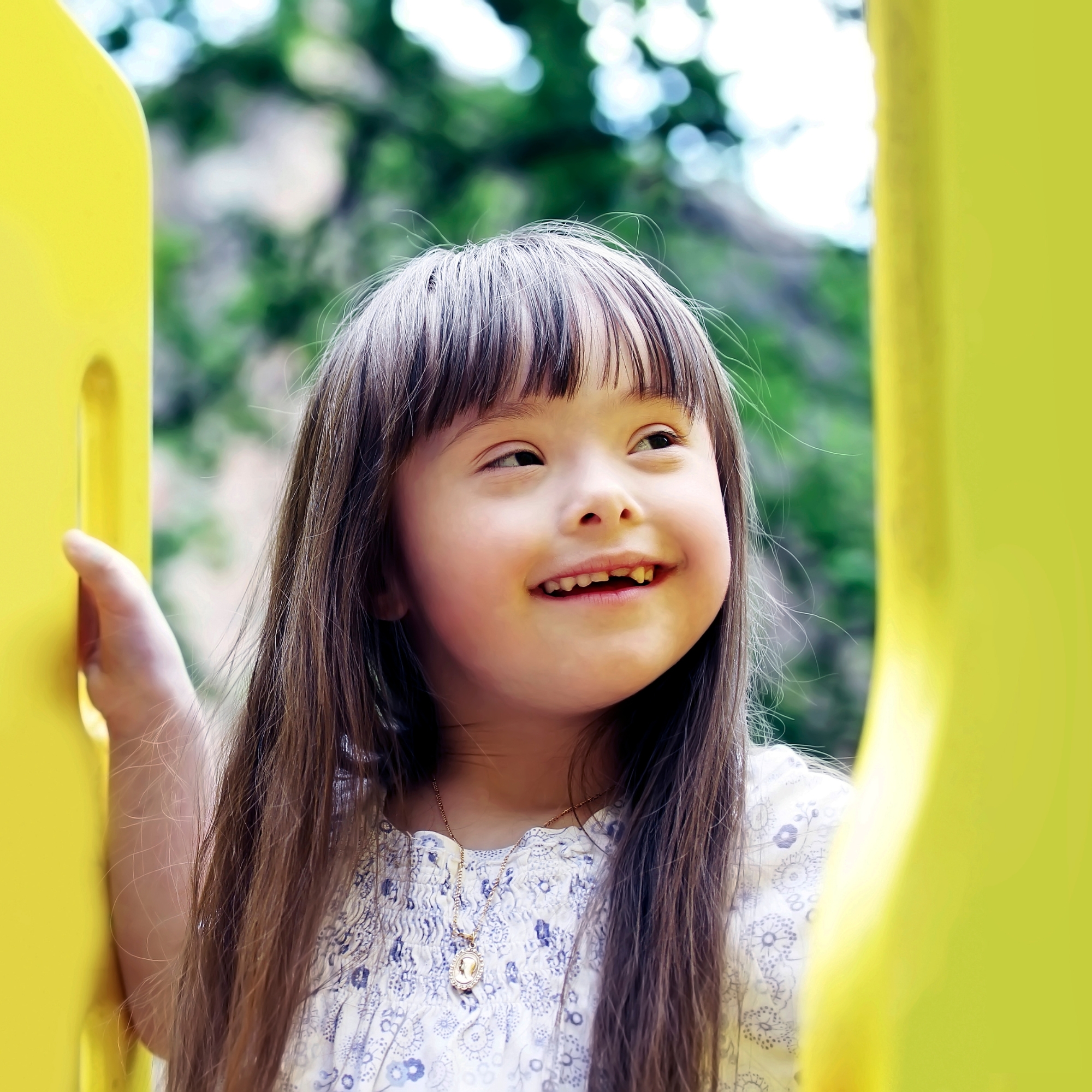 a young girl smiling upward