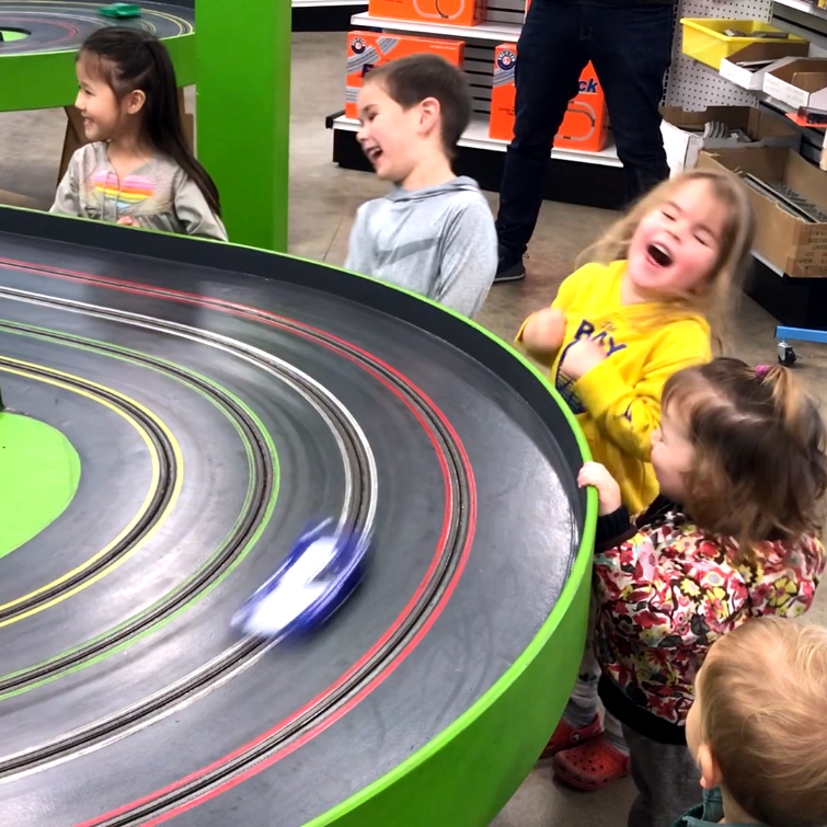 Kids-laughing-at-slot-car-race image